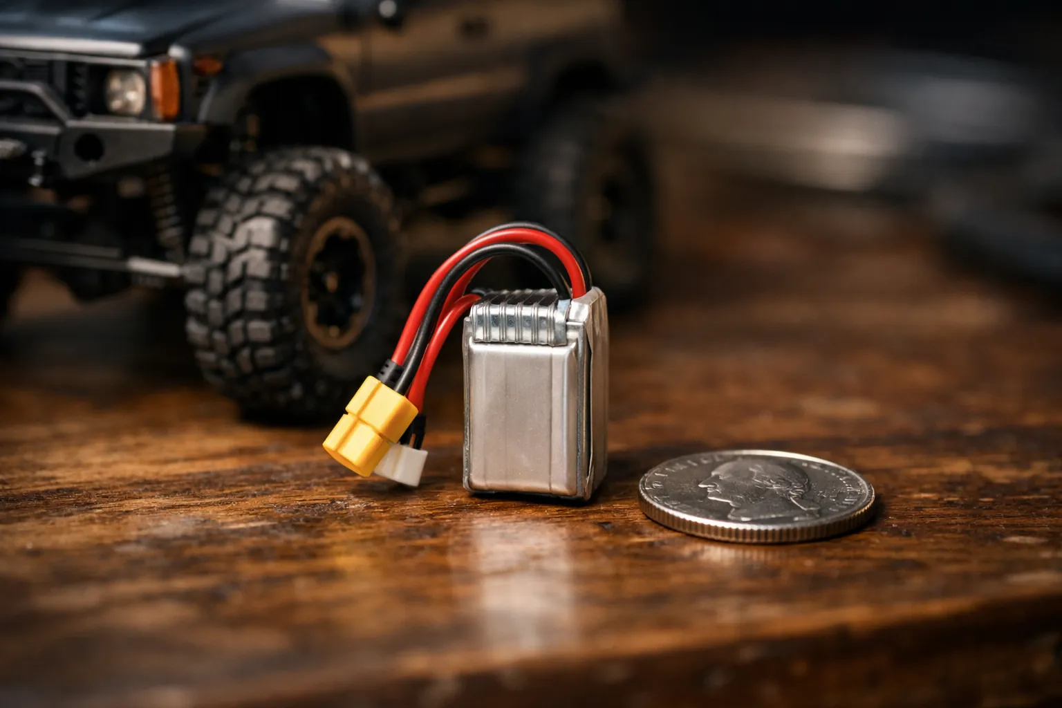 A tiny RC LiPo battery next to a micro crawler