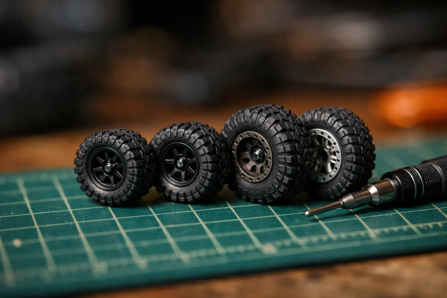 Tiny micro crawler wheels and tires on a cutting mat